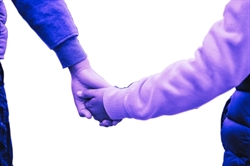[ai] Two hands holding each other, one belonging to an adult and the other to a child, against a white background. The image has a purple tint.